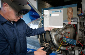 man wearing ar headset performing a task on a machine