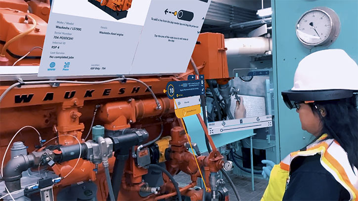 woman in hard hat inspecting a machine using ar work instructions