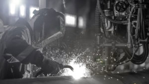 man welding a piece of equipment