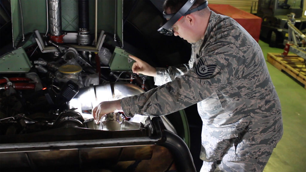 USAF airman performing maintenance with ar headset