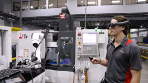 man wearing ar headset to perform a task on a machine