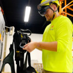 telecom worker using ar instructions for safety harness