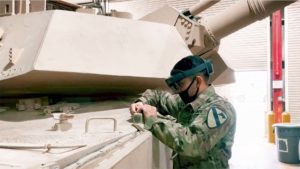 soldier working on a tank while using augmented reality headset