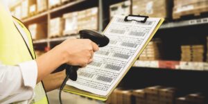 person scanning clipboard of barcodes