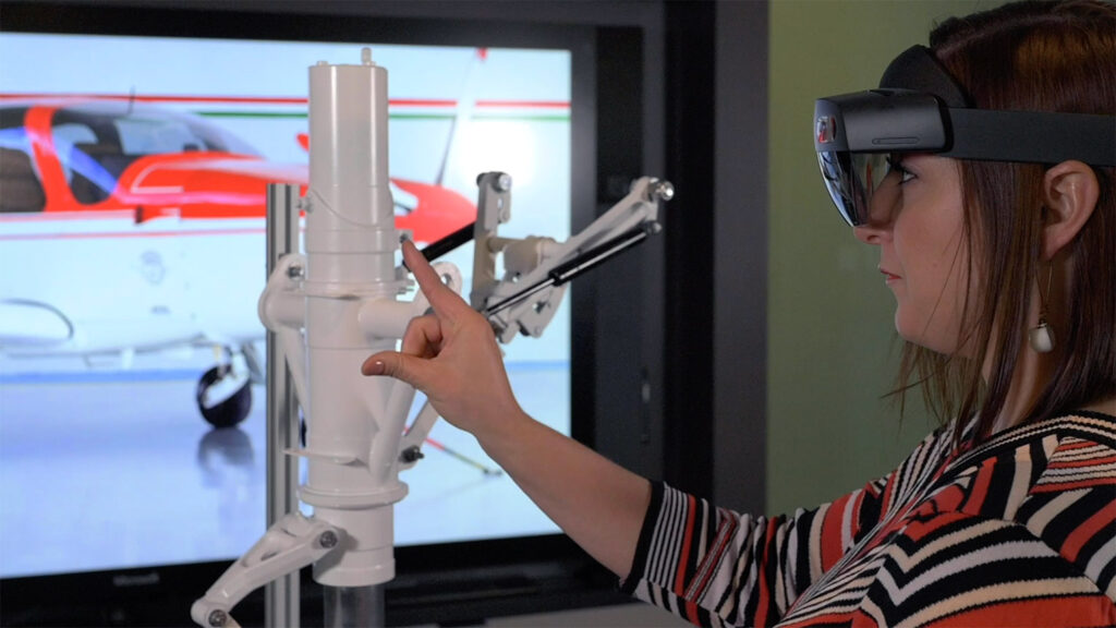 woman inspecting aircraft landing gear with hololens ar goggles