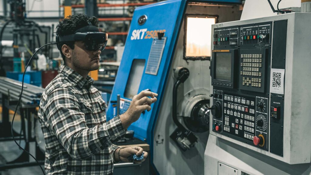man using augmented work instructions and headset on manufacturing floor
