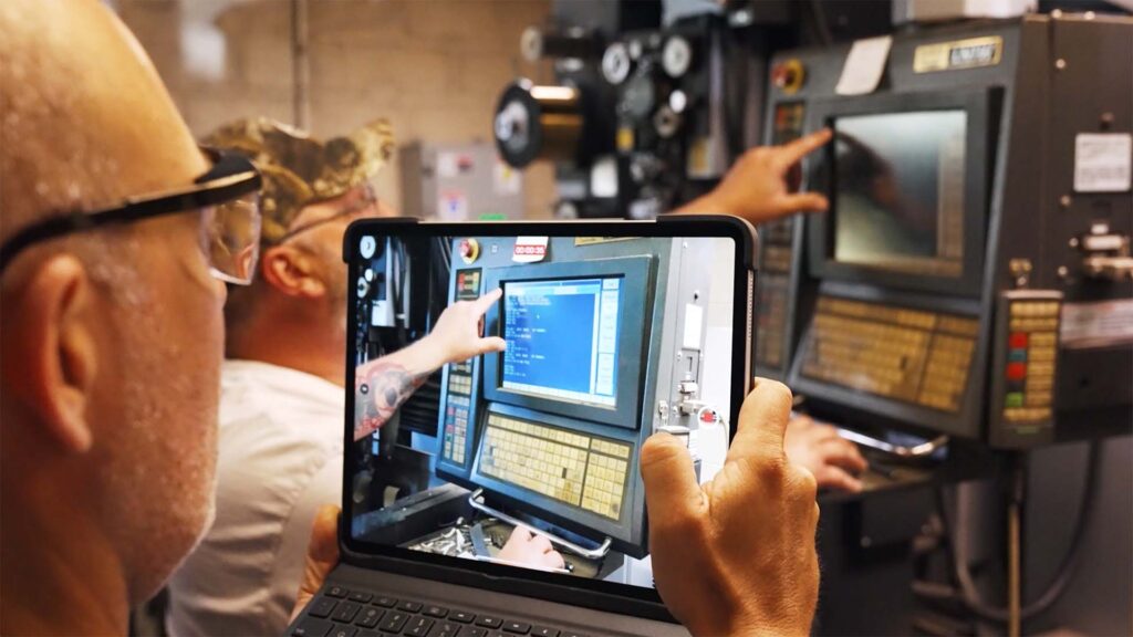 man viewing a machine through tablet camera