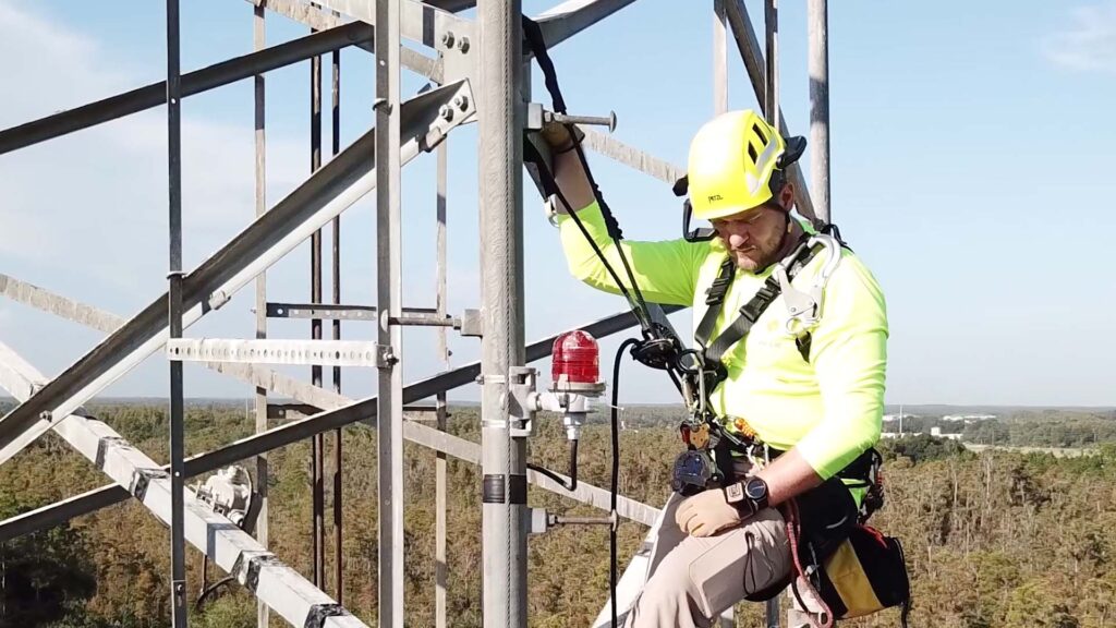 man on a cell tower wearing an ar headset