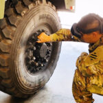 soldier using augmented reality goggles to pmcs a vehicle