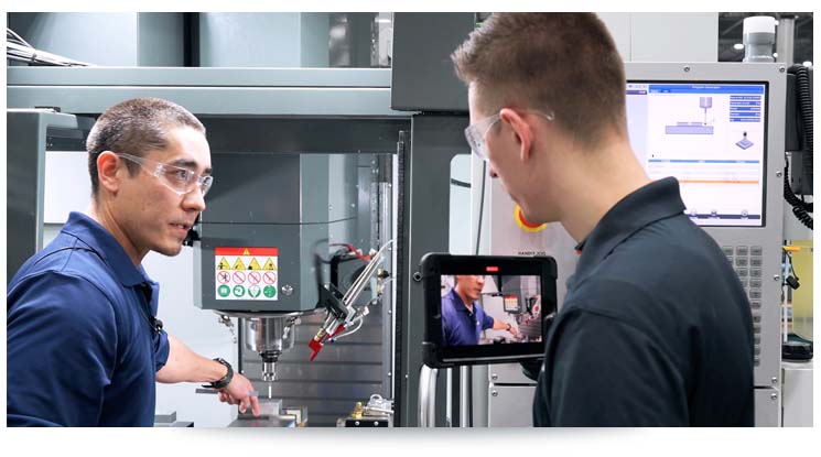 men using ar work instructions on a manufacturing machine