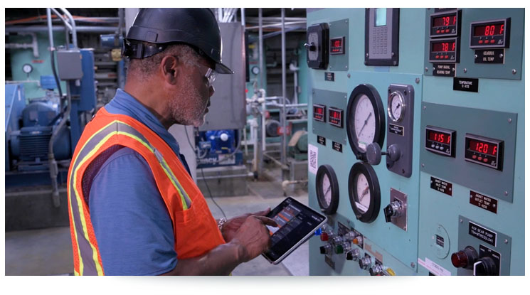 manufacturing employee using digital instructions on a tablet