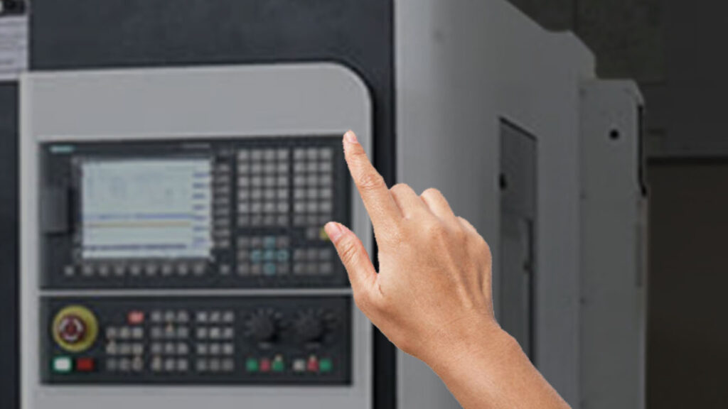 hand reaching toward machine panel
